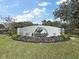 Beautiful community entrance sign with lush landscaping at 37007 Forestdel Dr, Eustis, FL 32736