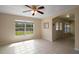 Open dining room with tile floors, large window, and arched doorway at 37007 Forestdel Dr, Eustis, FL 32736