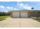 Spacious two-car garage with well-manicured landscaping and mature trees at 37007 Forestdel Dr, Eustis, FL 32736