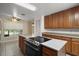 Kitchen with wooden cabinetry, a smooth cooktop, and stainless steel appliances at 37007 Forestdel Dr, Eustis, FL 32736