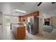 Well-equipped kitchen showcasing stainless steel appliances, tiled floors, and a breakfast bar for casual dining at 37007 Forestdel Dr, Eustis, FL 32736