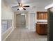 Bright eat-in kitchen featuring tile flooring, a ceiling fan, and ample natural light from a large window at 37007 Forestdel Dr, Eustis, FL 32736