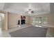 Open living room with fireplace, tile floors and access to the patio at 37007 Forestdel Dr, Eustis, FL 32736