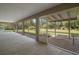 Covered and screened outdoor patio area with access to the yard, offering a serene space for relaxation at 37007 Forestdel Dr, Eustis, FL 32736
