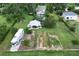 Expansive property featuring a home, recreational vehicle, metal outbuilding, cultivated garden, and lush landscaping at 37138 Lake Yale Pl, Grand Island, FL 32735