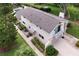 Aerial view of the rear exterior featuring a driveway and landscaped yard at 37138 Lake Yale Pl, Grand Island, FL 32735