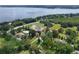 Lush property with mature trees has a sprawling green lawn with a red outline of the property at 37138 Lake Yale Pl, Grand Island, FL 32735