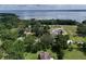 Lakeside property with a home, a pool, outbuildings and treelined street at 37138 Lake Yale Pl, Grand Island, FL 32735