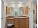 Bathroom vanity with wooden cabinets, tiled countertops, and a view of the outdoors at 37138 Lake Yale Pl, Grand Island, FL 32735