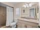 This bathroom has a granite countertop vanity and shower with white curtain at 37138 Lake Yale Pl, Grand Island, FL 32735