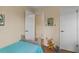 Cozy bedroom with simple decor, featuring a twin bed and playroom items at 37138 Lake Yale Pl, Grand Island, FL 32735