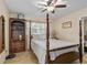 Bedroom featuring a four-poster bed, and a bookshelf at 37138 Lake Yale Pl, Grand Island, FL 32735