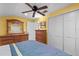 Bedroom with ceiling fan, dresser with mirror, chest of drawers and closet at 37138 Lake Yale Pl, Grand Island, FL 32735