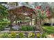 Picturesque cabana provides an ideal spot for relaxation next to the pool at 37138 Lake Yale Pl, Grand Island, FL 32735