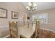 Eat-in dining area featuring a large table, chandelier and bright window at 37138 Lake Yale Pl, Grand Island, FL 32735