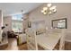 Bright dining area featuring chandelier and open floorplan with living area at 37138 Lake Yale Pl, Grand Island, FL 32735