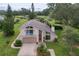 Inviting two-story home with balcony, lush landscaping, and a well-maintained lawn at 37138 Lake Yale Pl, Grand Island, FL 32735