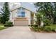 Charming two-story home with a balcony, two-car garage and landscaped yard at 37138 Lake Yale Pl, Grand Island, FL 32735