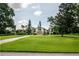 A large front yard leads to this charming home with lush landscaping and mature trees at 37138 Lake Yale Pl, Grand Island, FL 32735