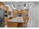 Open kitchen featuring a large island, wooden cabinets and stainless steel appliances at 37138 Lake Yale Pl, Grand Island, FL 32735