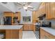 Bright kitchen with stainless steel appliances, wood cabinets, and an island at 37138 Lake Yale Pl, Grand Island, FL 32735