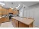 Spacious kitchen with a large island, stainless steel appliances, and ample cabinet space at 37138 Lake Yale Pl, Grand Island, FL 32735