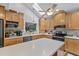 Bright kitchen with wood cabinets, stainless steel appliances, and an eat-in island at 37138 Lake Yale Pl, Grand Island, FL 32735