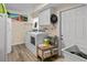 Laundry room includes a washer, dryer, storage, shelving and utility sink at 37138 Lake Yale Pl, Grand Island, FL 32735