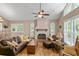 Cozy living room features a ceiling fan, wood flooring, and lots of natural light at 37138 Lake Yale Pl, Grand Island, FL 32735