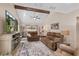 Spacious living room with beamed ceilings, fan, and comfortable seating at 37138 Lake Yale Pl, Grand Island, FL 32735