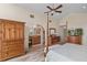 An open concept primary bedroom with an archway to a ensuite bathroom and wood furnishings at 37138 Lake Yale Pl, Grand Island, FL 32735