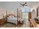 A primary bedroom featuring high ceilings, wood floors and a four poster bed at 37138 Lake Yale Pl, Grand Island, FL 32735