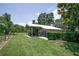 Large outbuilding with metal roof and covered area ideal for equipment storage at 37138 Lake Yale Pl, Grand Island, FL 32735