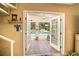View of the sparkling pool with an outdoor seating area, as seen through open French doors at 37138 Lake Yale Pl, Grand Island, FL 32735