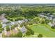 Scenic aerial view of a two-story home with mature landscaping neighboring the community park at 4445 Blue Major Dr, Windermere, FL 34786