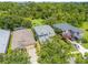 An aerial view of a two-story home with a lawn and mature landscaping surrounded by lush trees at 4445 Blue Major Dr, Windermere, FL 34786
