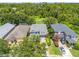 An aerial view of a two-story home with a lawn and mature landscaping, neighbored by well kept homes at 4445 Blue Major Dr, Windermere, FL 34786