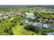 A scenic aerial view of the community and home with mature landscaping adjacent to the community park at 4445 Blue Major Dr, Windermere, FL 34786