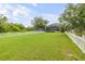 Expansive backyard with a white picket fence and views of the home with screened pool at 4445 Blue Major Dr, Windermere, FL 34786