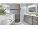 Bathroom showcasing a soaking tub, glass shower, and vanity at 4445 Blue Major Dr, Windermere, FL 34786