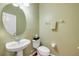 Cozy half bathroom featuring a pedestal sink and a toilet with a towel rack at 4445 Blue Major Dr, Windermere, FL 34786