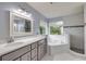 Bathroom with a tub, shower, and vanity featuring granite countertops at 4445 Blue Major Dr, Windermere, FL 34786