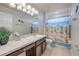 Bathroom featuring neutral color and lots of cabinet space and shower/tub combo at 4445 Blue Major Dr, Windermere, FL 34786