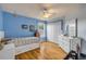 Bedroom featuring blue accent wall, hardwood floors, and an oversized closet at 4445 Blue Major Dr, Windermere, FL 34786