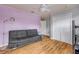 Bedroom featuring purple accent wall, hardwood floors, and double door closet at 4445 Blue Major Dr, Windermere, FL 34786