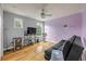 Bedroom featuring purple accent wall, hardwood floors, and lots of light at 4445 Blue Major Dr, Windermere, FL 34786
