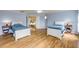 Spacious bedroom with two beds, wood floors, and bright blue walls at 4445 Blue Major Dr, Windermere, FL 34786
