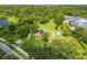 Aerial view of the community park featuring a playground, mature trees, and benches at 4445 Blue Major Dr, Windermere, FL 34786