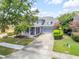 Charming two-story home with a well-manicured lawn, red front door, and an attached two-car garage at 4445 Blue Major Dr, Windermere, FL 34786