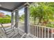 Inviting covered front porch with two rocking chairs and lovely view of the landscaped front yard at 4445 Blue Major Dr, Windermere, FL 34786
